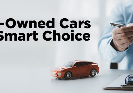 Person using a calculator with car keys and a toy car on the desk, alongside text "Why Pre-Owned Cars Are the Smart Choice".