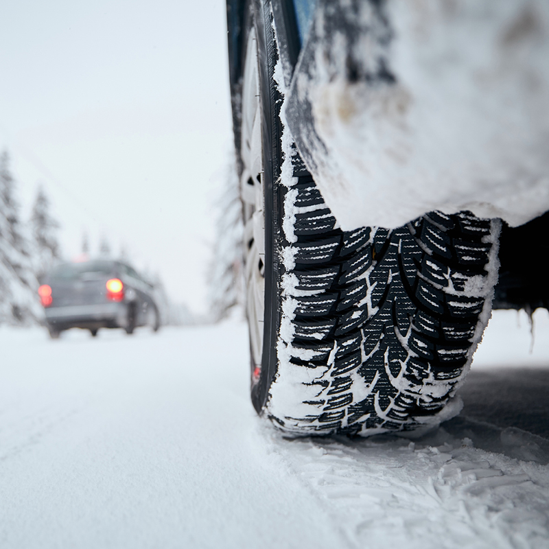 SUV driving through snowy conditions
